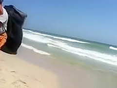 Woman with a big ass on the beach