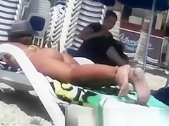 Woman with a big ass on the beach