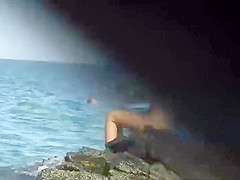 Zooming on a nudist girl's shaved pussy