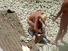 Busty blonde nudist swimming in the water