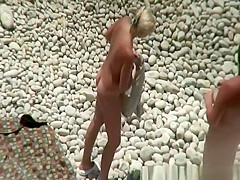 Busty blonde nudist swimming in the water