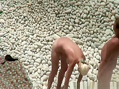 Busty blonde nudist swimming in the water