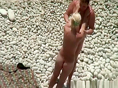 Busty blonde nudist swimming in the water