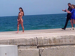 Perky boobed attractive babe walks outdoor naked on beach