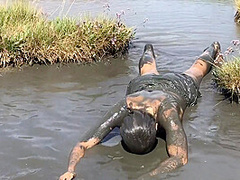 Sexy Girl Playing In The River Mud. Muddy Fun (fully Clothed)