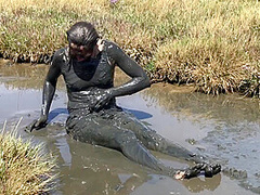 Sexy Girl Playing In The River Mud. Muddy Fun (fully Clothed)