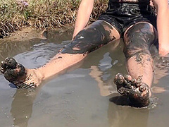 Sexy Girl Playing In The River Mud. Muddy Fun (fully Clothed)