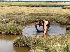 Sexy Girl Playing In The River Mud. Muddy Fun (fully Clothed)