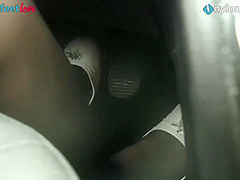 Redhead drives a car, shows upskirt and feet in stockings