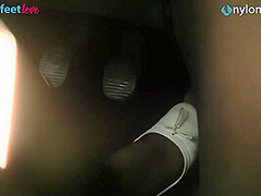 Redhead drives a car, shows upskirt and feet in stockings