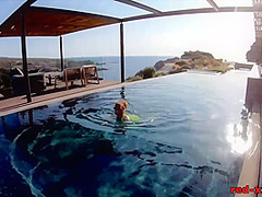 Red XXX fucks her pussy with a toy in the pool