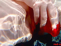 Red XXX fucks her pussy with a toy in the pool
