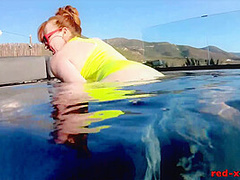 Red XXX fucks her pussy with a toy in the pool