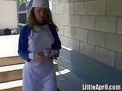 Little April rubs her pussy after baseball