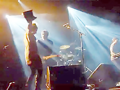 Audience girl strips on stage during a concert