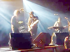 Audience girl strips on stage during a concert