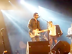 Audience girl strips on stage during a concert