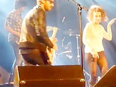 Audience girl strips on stage during a concert