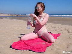 Sheer wet bikini on a public beach