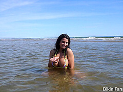 Topless bikini model on the beach