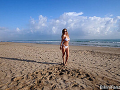 Naturally busty bikini babe on the beach