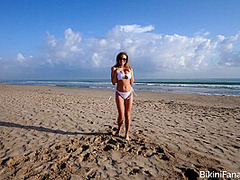 Naturally busty bikini babe on the beach