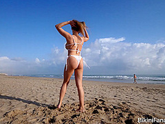Naturally busty bikini babe on the beach