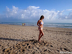 Naturally busty bikini babe on the beach