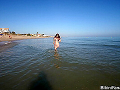 Amateur bikini model bares it all on a public beach