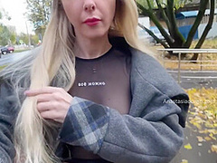 A Girl Shows Her Breasts While Walking Around City