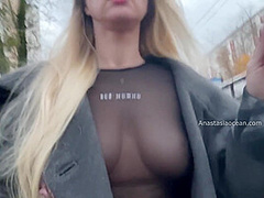 A Girl Shows Her Breasts While Walking Around City