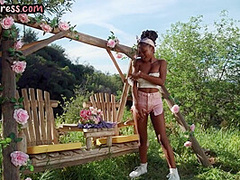 Busty Ebony babe in high heel boots fingering pussy outdoor