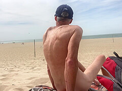 Dildo anal insertion on public beach