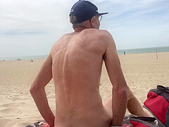 Dildo anal insertion on public beach