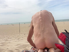 Dildo anal insertion on public beach