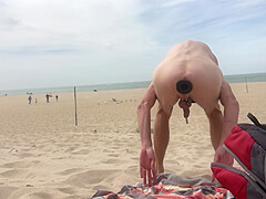 Dildo anal insertion on public beach