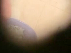 A covert camera captures a black-clad Asian whore.