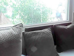 Hairy mature flashing in front of window