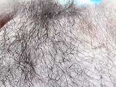 Hairy mature flashing in front of window