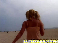 Petite teen masturbating on the beach