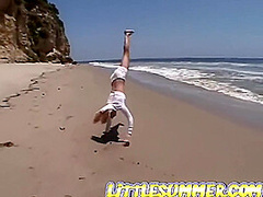 Petite teen lesbian fingered on the beach