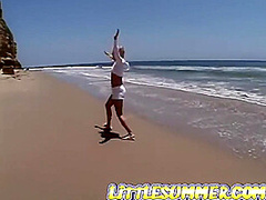 Petite teen lesbian fingered on the beach
