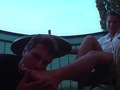 Sexy femdom smoking a cigarette while getting feet licked and toes sucked by Foot Girls