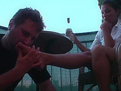 Sexy femdom smoking a cigarette while getting feet licked and toes sucked by Foot Girls