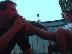 Sexy femdom smoking a cigarette while getting feet licked and toes sucked by Foot Girls