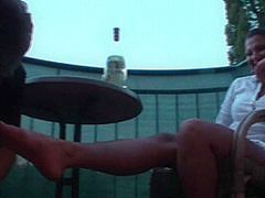 Sexy femdom smoking a cigarette while getting feet licked and toes sucked by Foot Girls