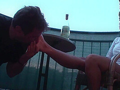 Sexy femdom smoking a cigarette while getting feet licked and toes sucked by Foot Girls