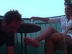 Sexy femdom smoking a cigarette while getting feet licked and toes sucked by Foot Girls