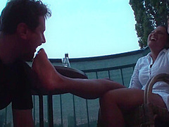 Sexy femdom smoking a cigarette while getting feet licked and toes sucked by Foot Girls