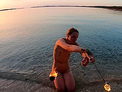 Hot Ginger Professional Fire Dancer Lea Playing With Her Flames On The Beach During Sunset